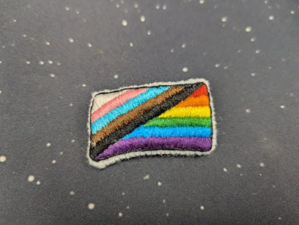 New Pride Flag crossstitch pin 
by Kylee Wright 

design by Julia Feliz